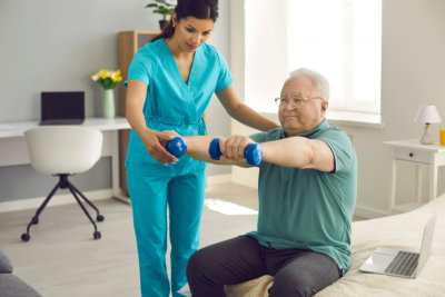 a caregiver assisting the elderly man